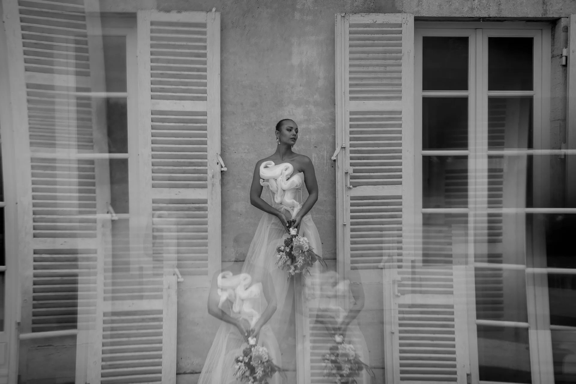 Artistic black and white bridal portrait with French shutters at Chateau de Varennes France